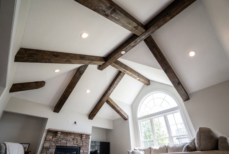 A vaulted ceiling with dark stained wood beams