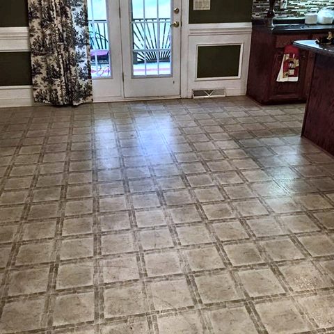 An open living and dining area with a new ceramic tile floor
