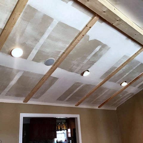 A vaulted ceiling with new timber beam framing fixed in place before finishing