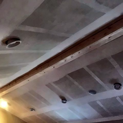 A vaulted ceiling drywalled and taped, with blocking in place ready for beams